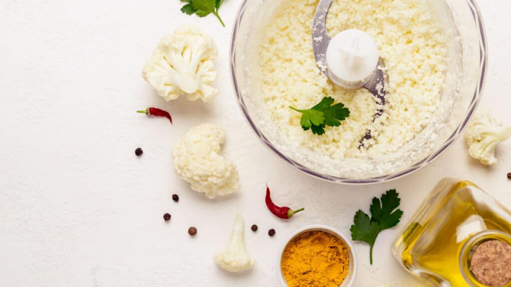 Cooking cauliflower rice closeup and ingredients on a white background.