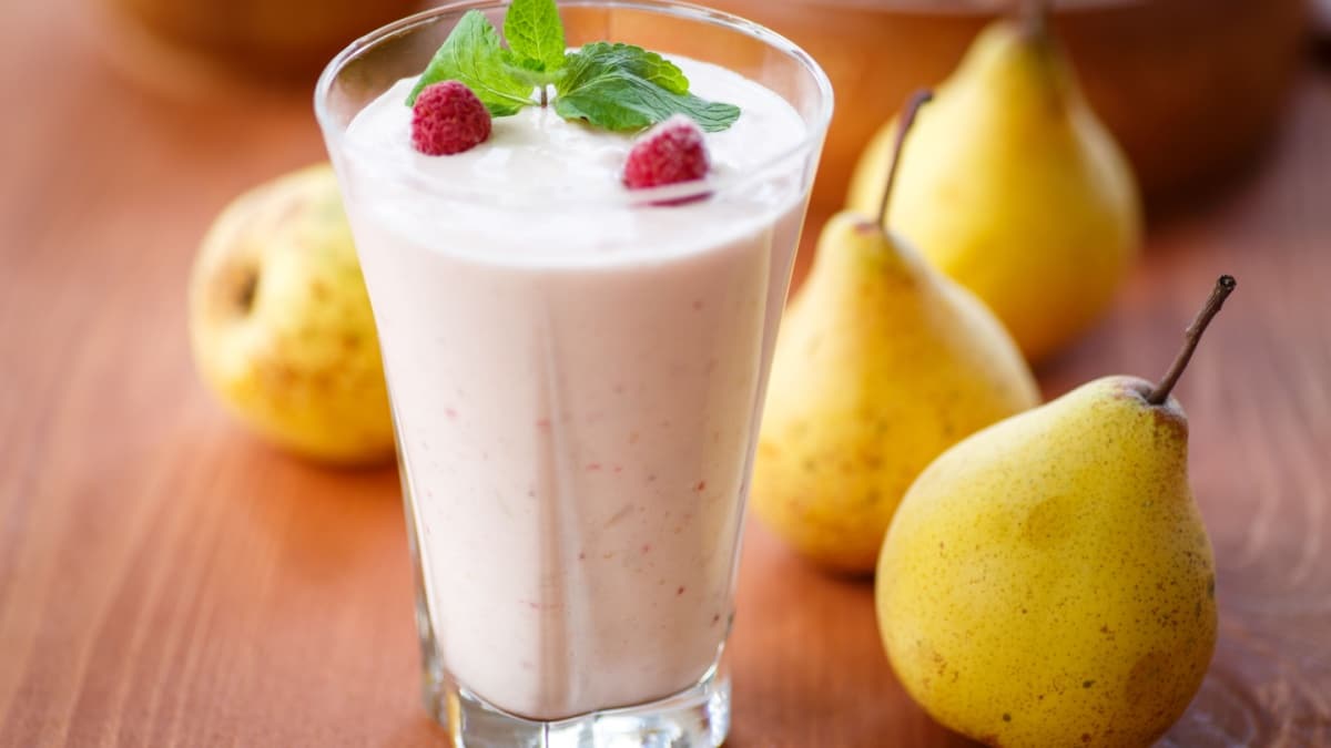 pear smoothie with berries and mint in a glass