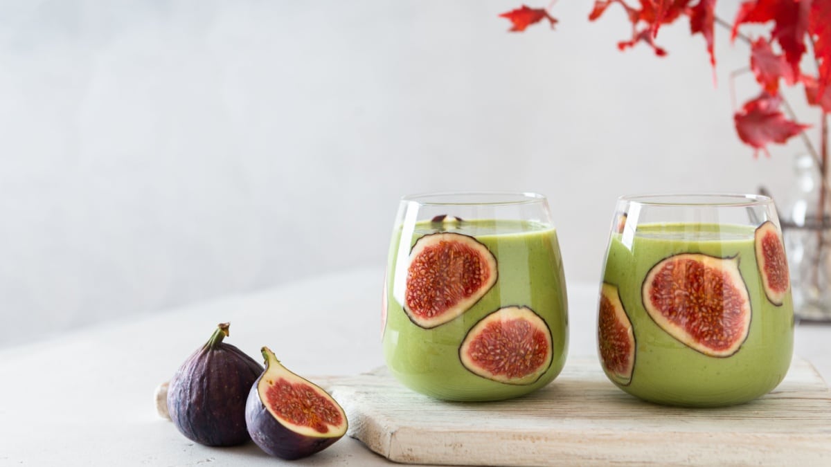 Matcha green vegan smoothie with chia seeds and figs in glasses on white background. Autumn detox recipe, superfoods, healthy eating. Japanese green matcha tea.