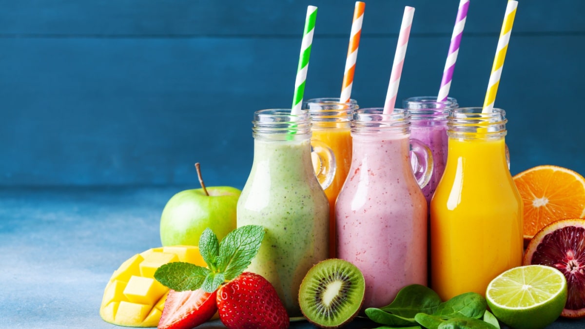 Summer colorful fruit smoothies in jars with ingredients. Healthy, detox and diet food concept.