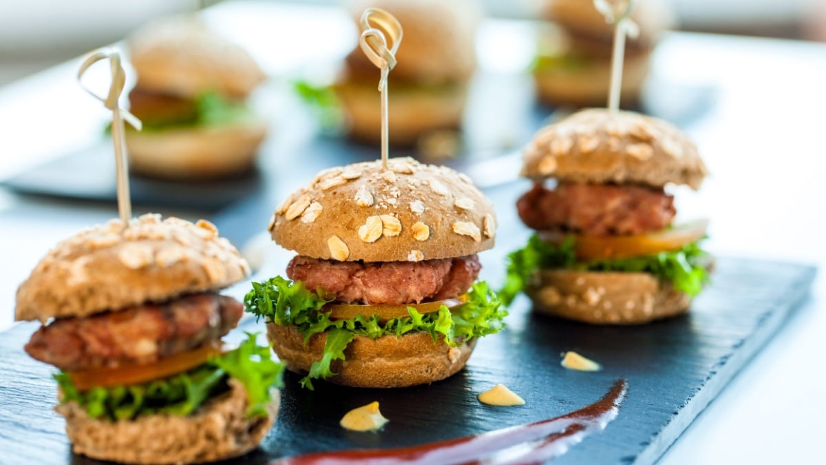 Close up of mini hamburgers at catering event.