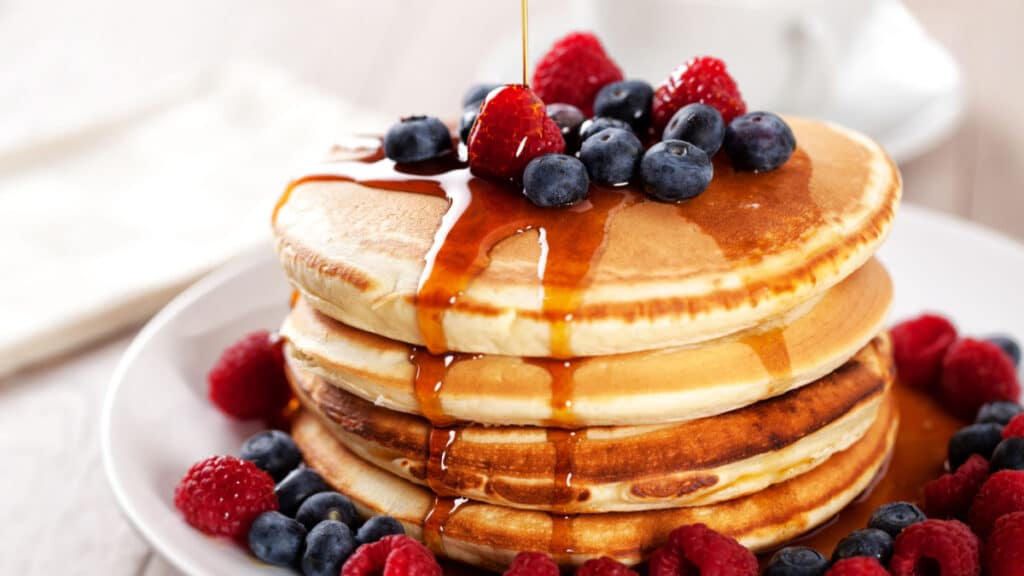 Pancakes with berries and maple syrup